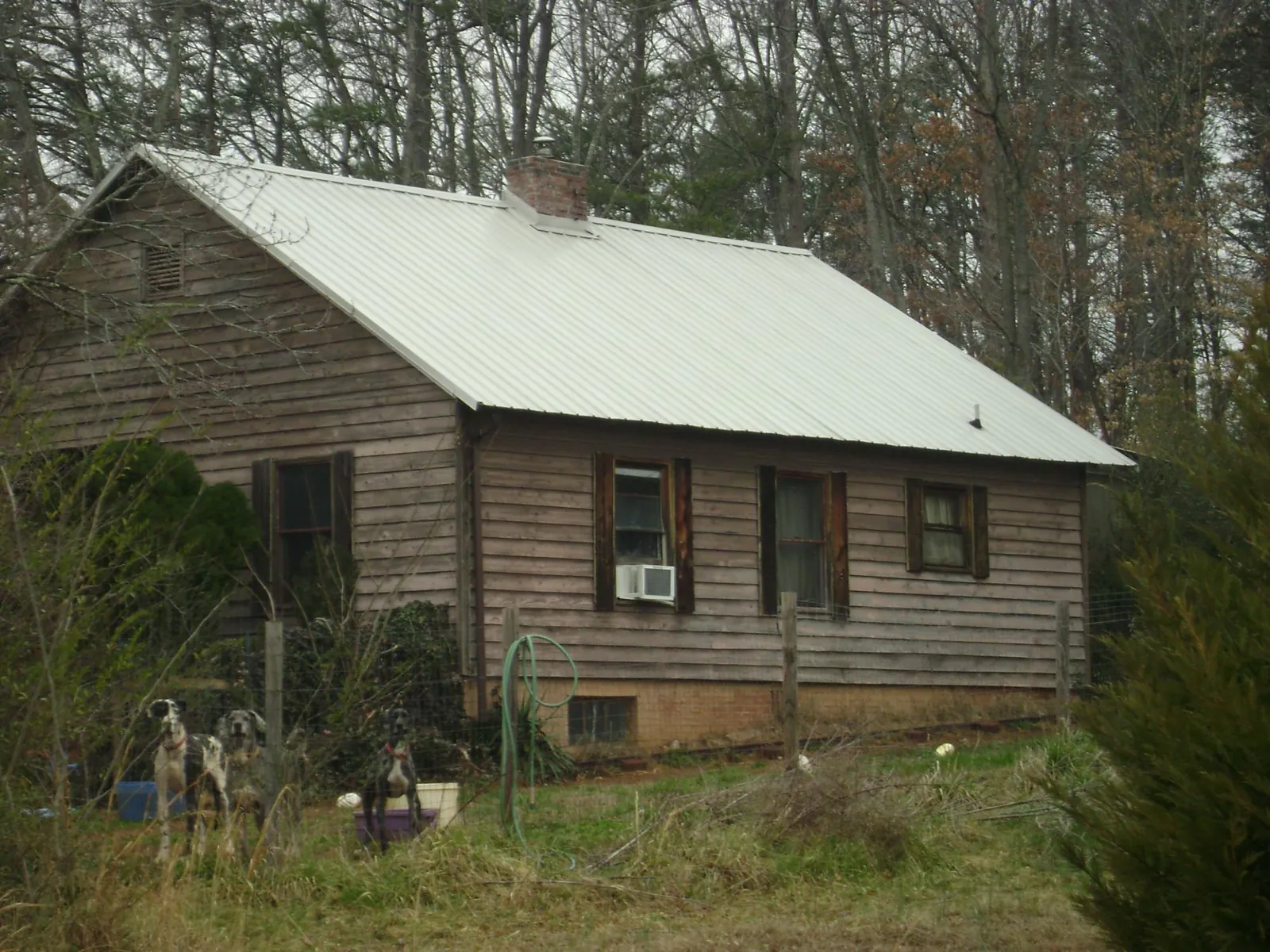 White metal roof on an old wood sided farmhouse, from a Metal Roof Installation job in Rillton